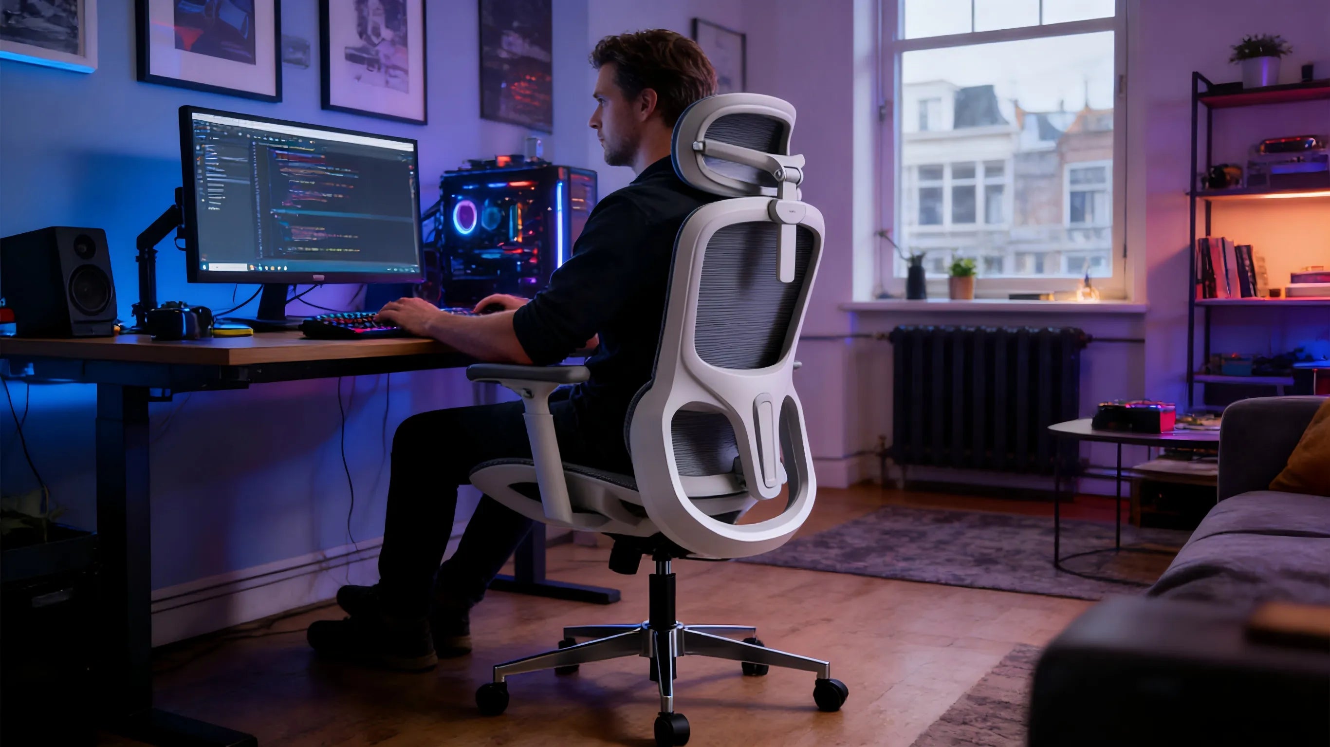 A professional developer and console gamer in Amsterdam using a white-framed gaming armchair.