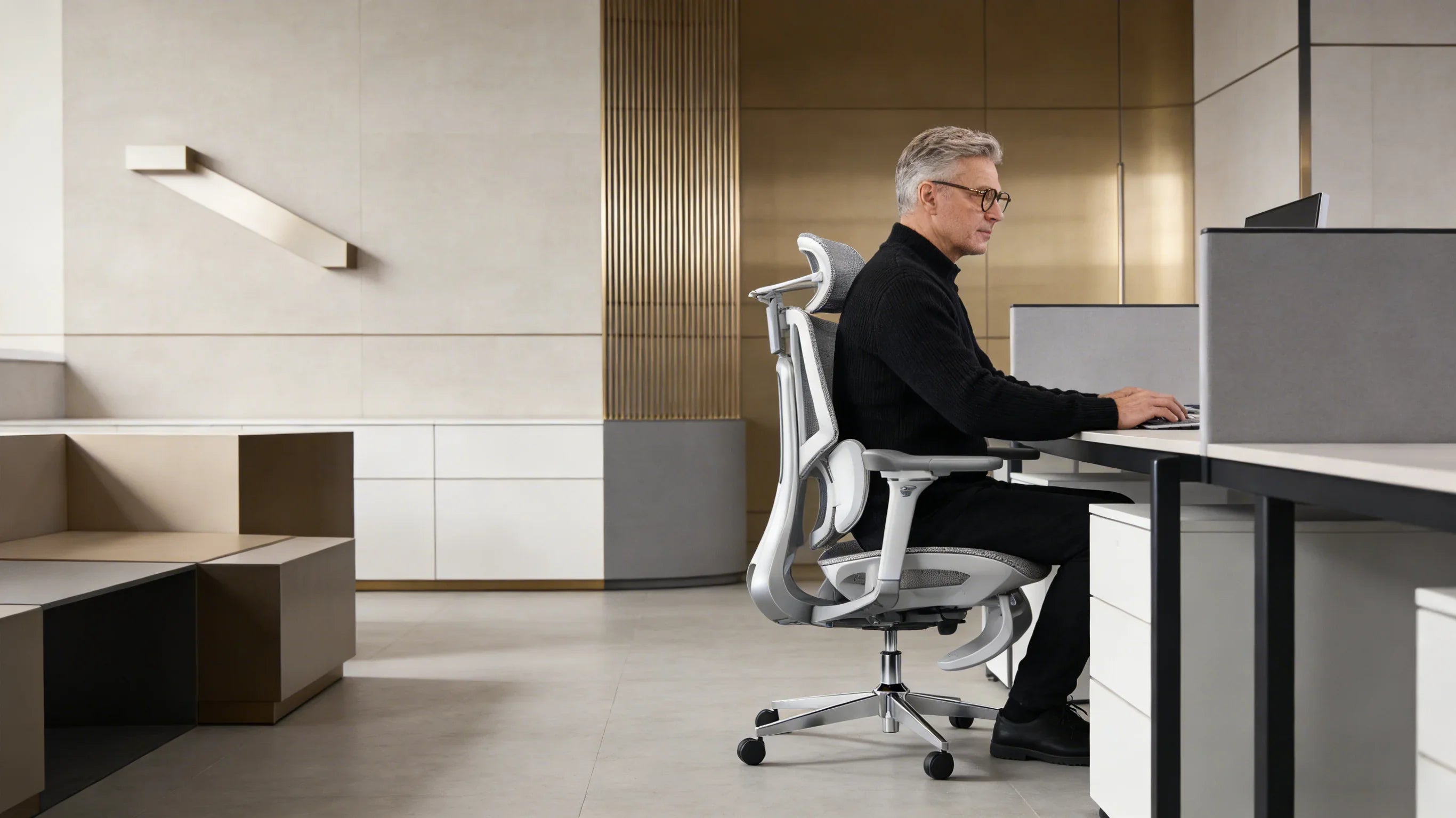 A senior European architect inspecting his [**best ergo desk chair**].