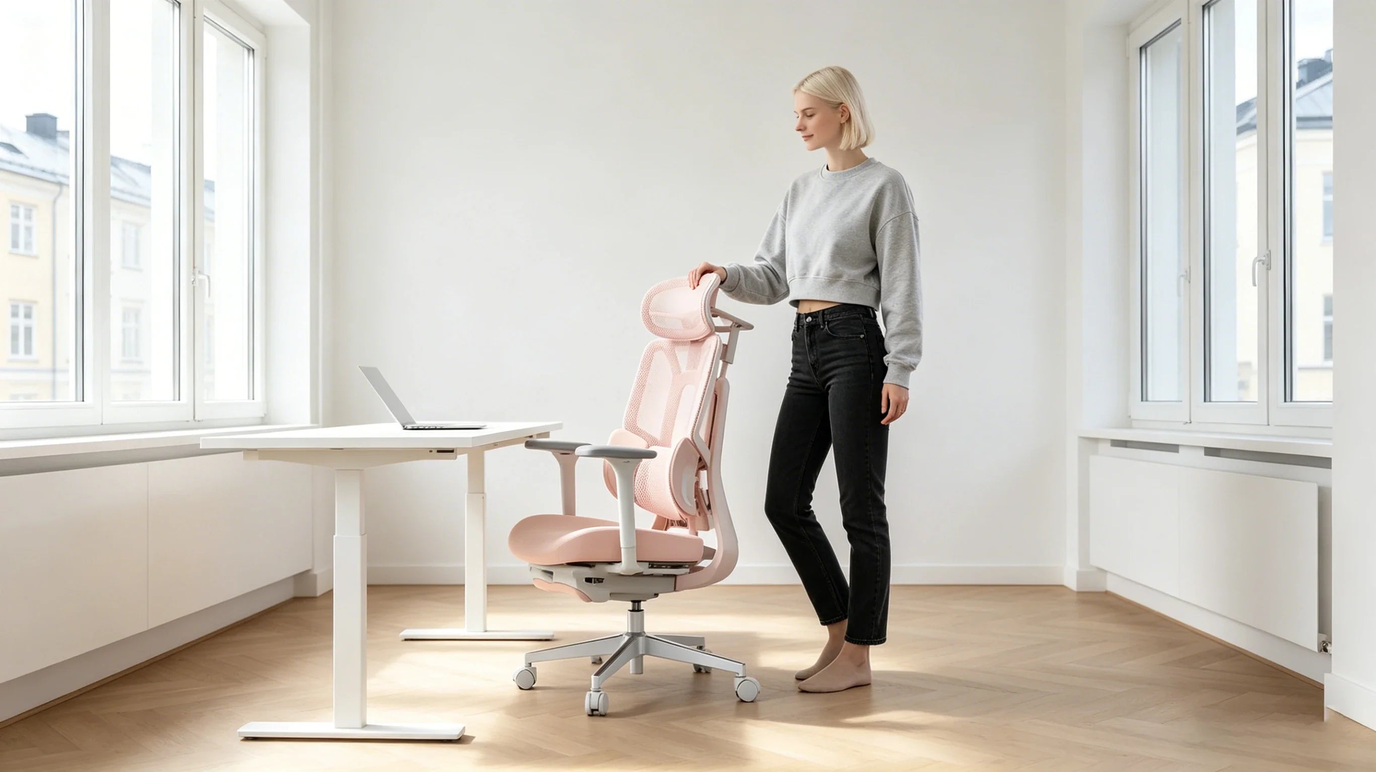 Saga adjusting the [desk chair adjustable height] to fit her minimalist desk.