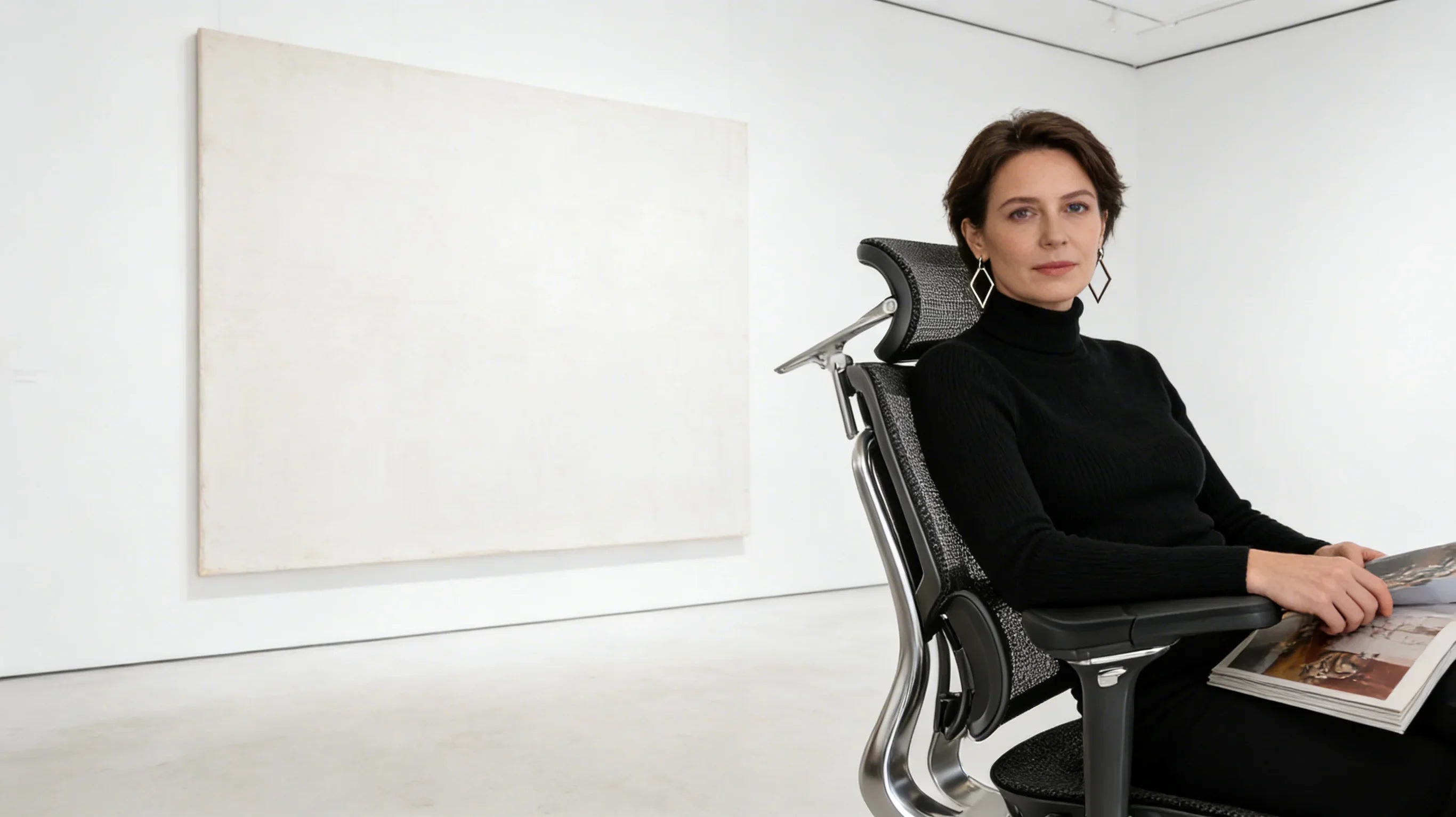 A European art curator sitting in her [**ergonomic desk chairs**].