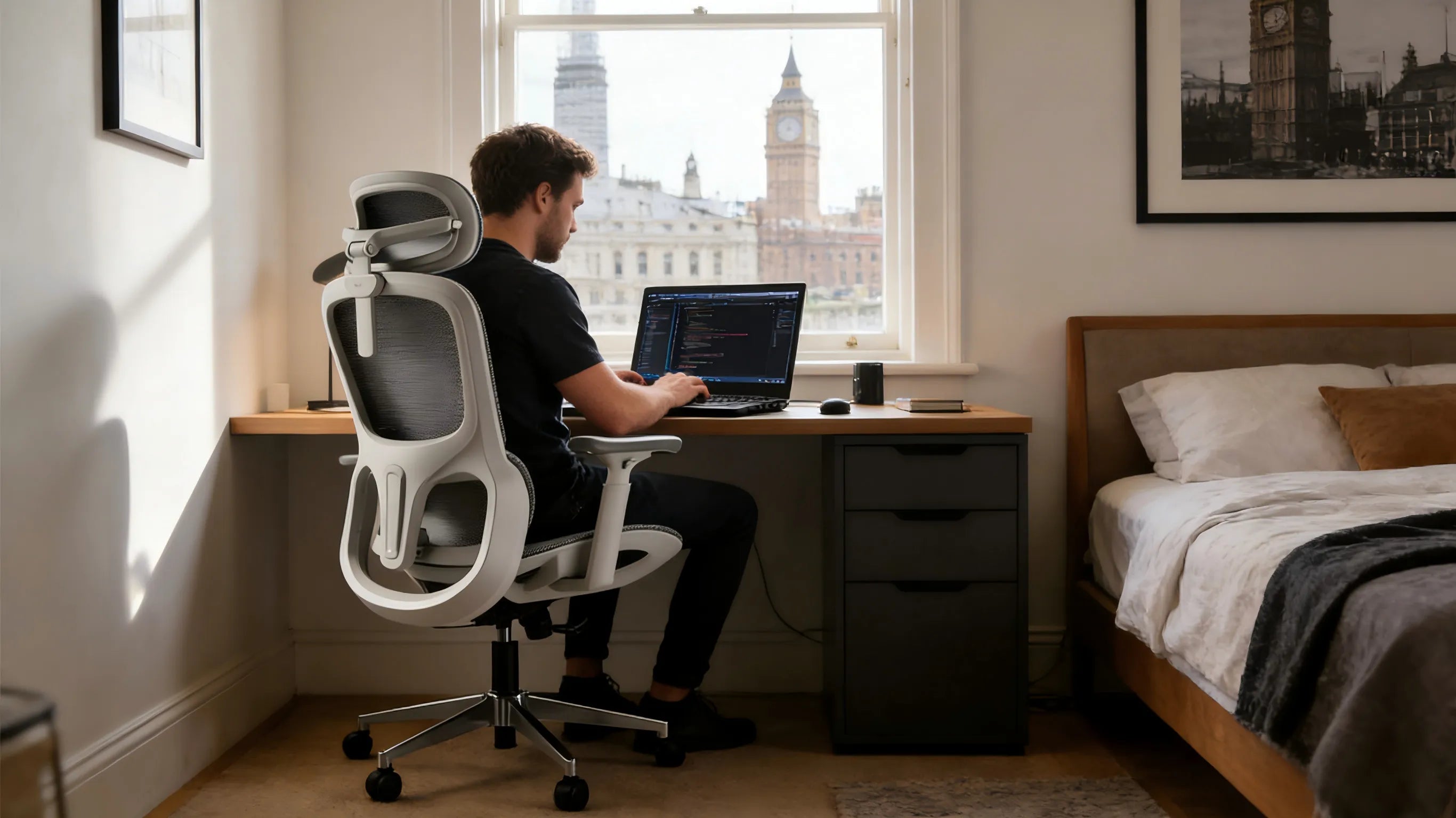 A professional remote developer in a London studio using a white-framed ergonomicoffice chair.