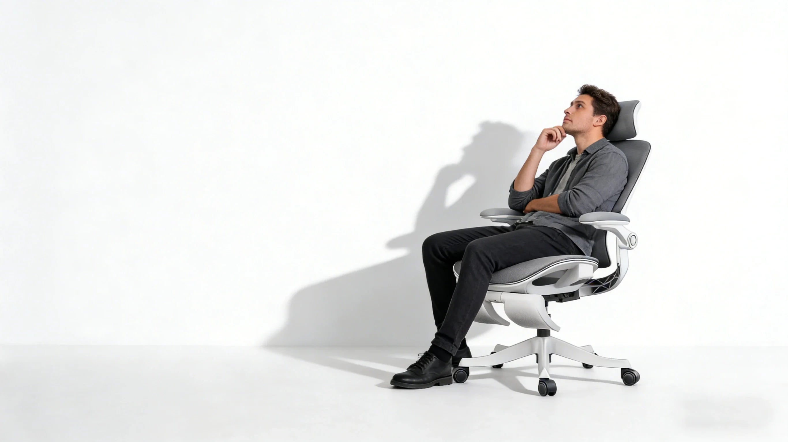 Side profile of a modern office chair highlighting its flowing S-curve lines and hidden adjustment levers against a soft-lit background.