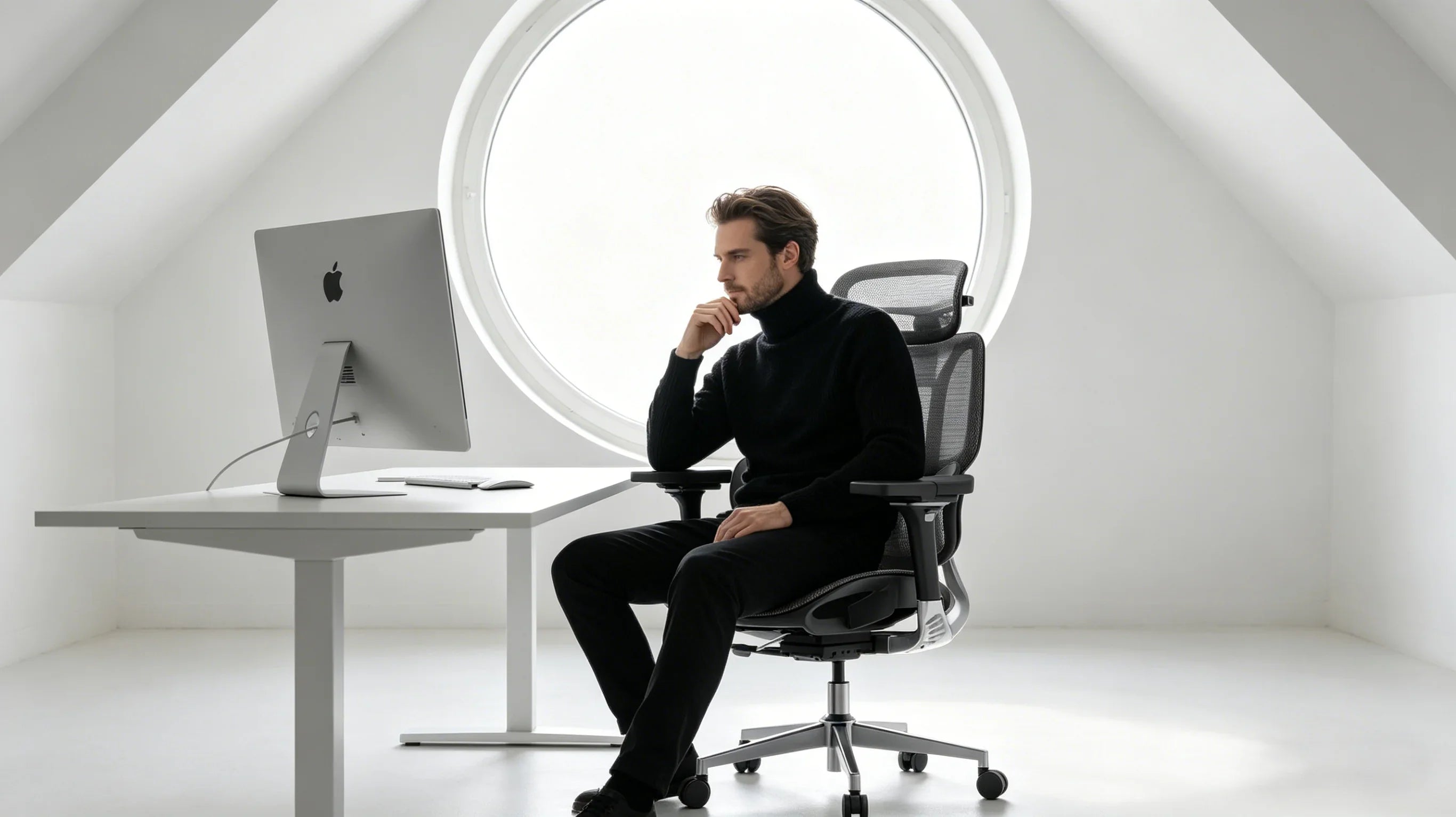A creative European director sitting in the [**perfect desk chair**] within a minimalist loft studio.
