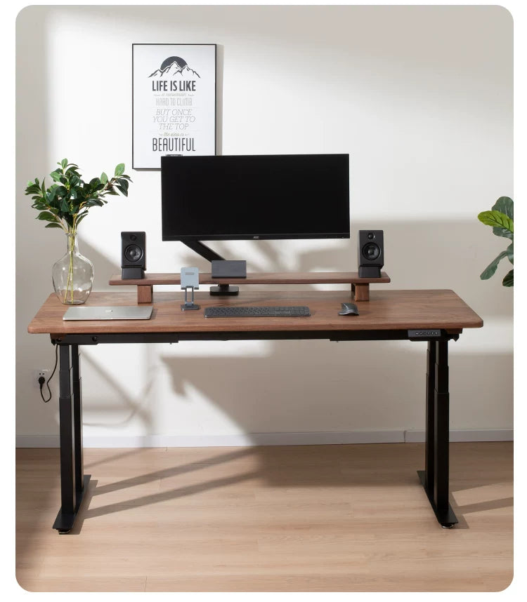 Four-motor solid walnut standing desk in an executive workspace