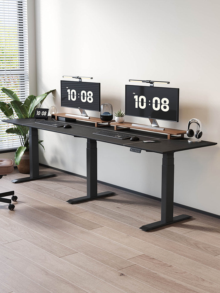 Extra-wide triple-motor standing desk configured for two people