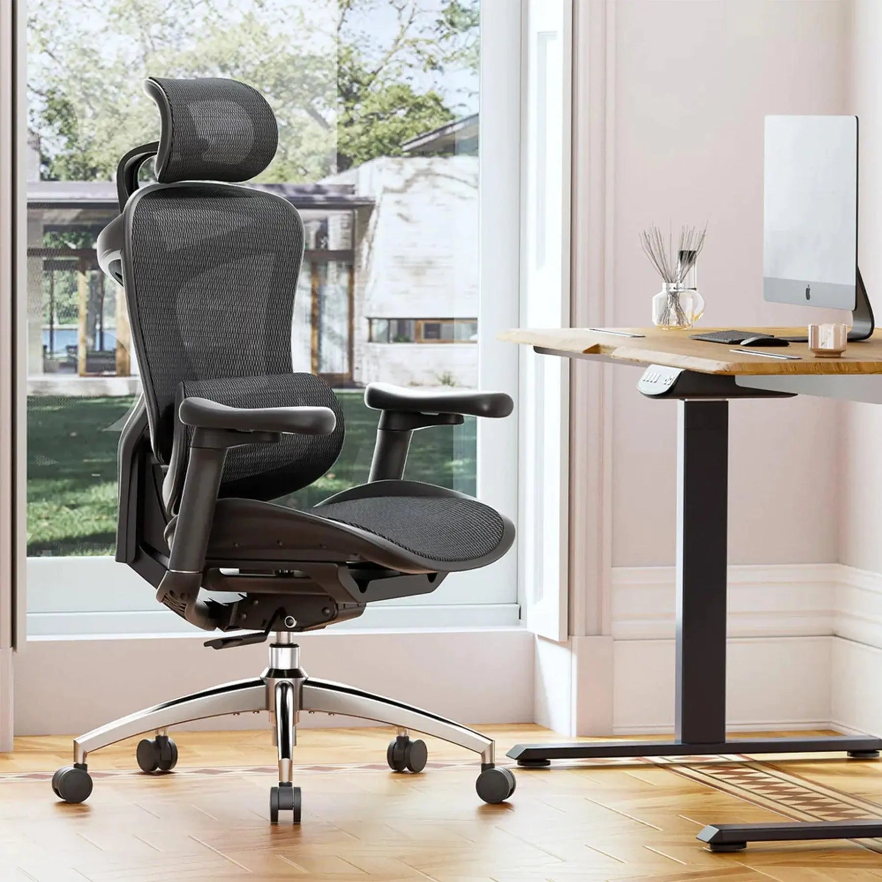 Close-up of the adjustable armrests on a black mesh ergonomic office chair for personalized comfort.