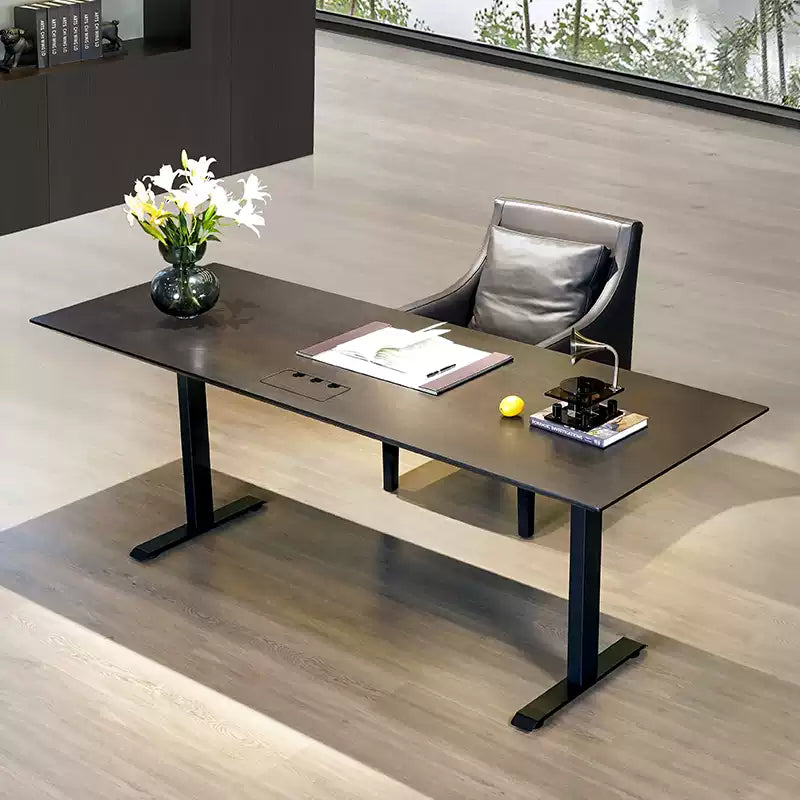 Black oak electric standing desk arranged as a contemporary workspace