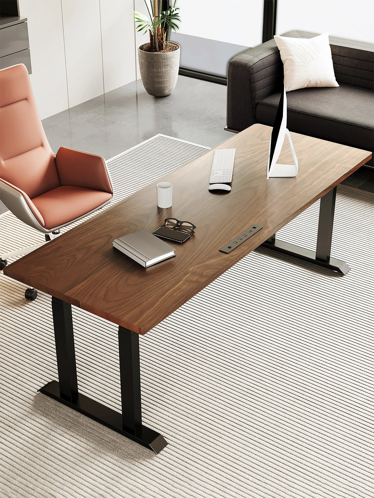Black walnut four-motor standing desk in a modern office