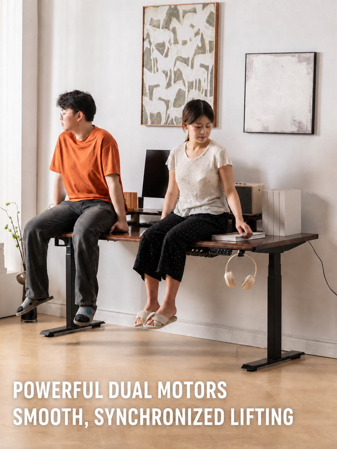 Dual-motor electric standing desk supporting a shared workspace