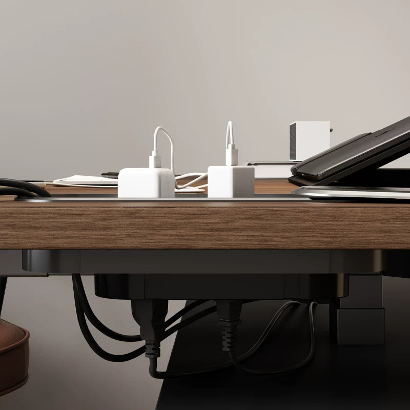 L-shaped electric standing desk shown with return-side workspace