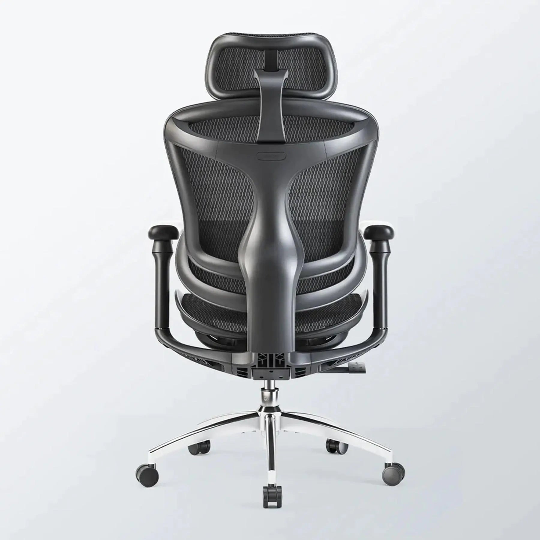 Close-up of the 6D adjustable armrests and premium mesh texture on a professional ergonomic office chair with footrest.