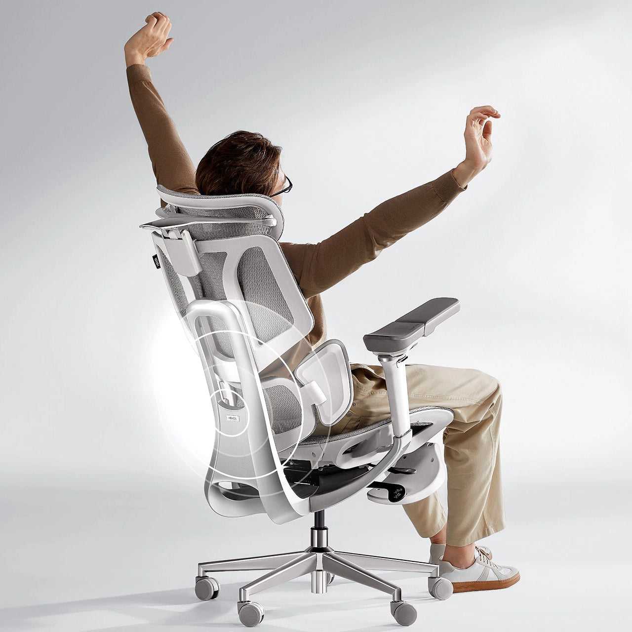 A software developer coding for long hours comfortably in a breathable mesh ergonomic office chair.