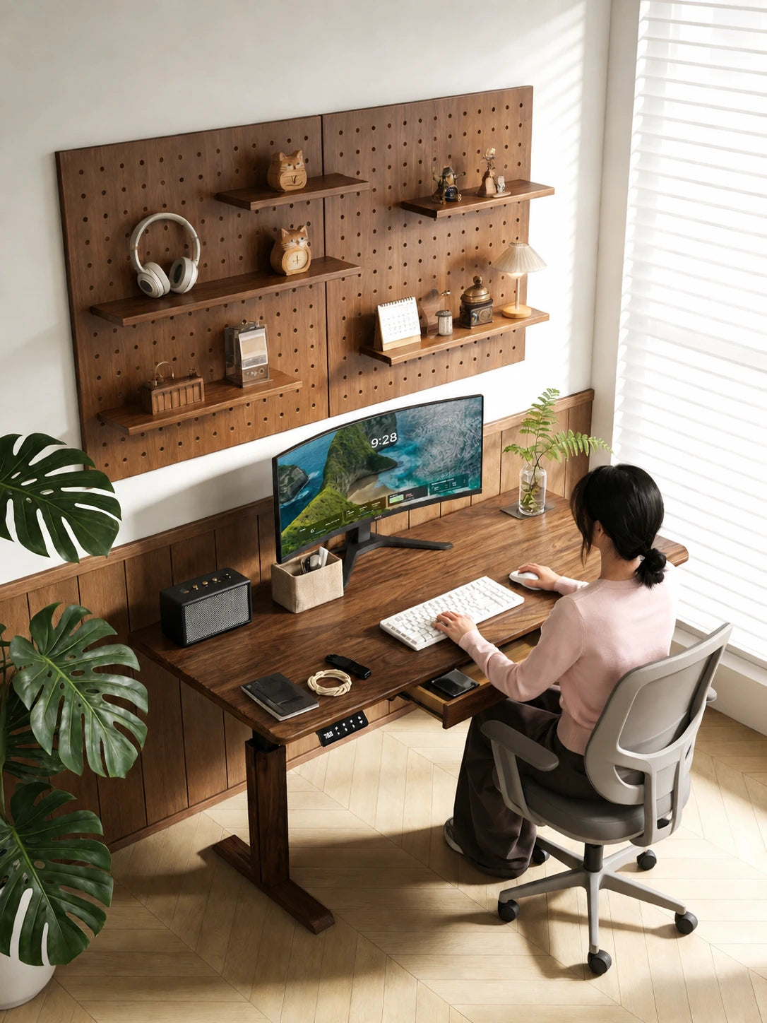 South American walnut electric standing desk with an integrated drawer in a bright home office