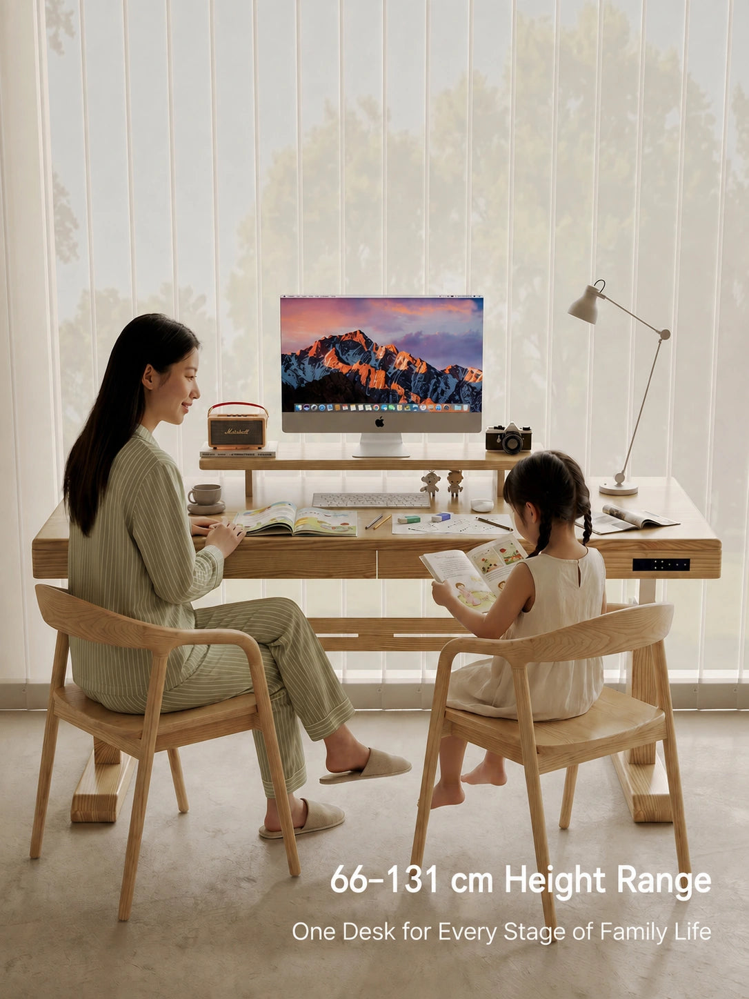 White ash height adjustable desk used by a parent and child in a bright home office