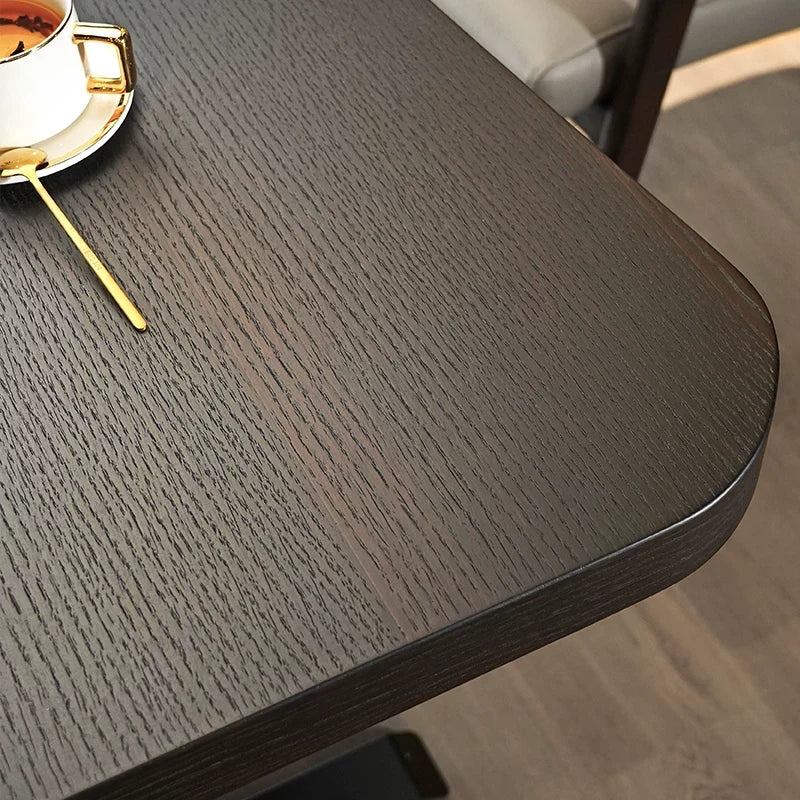 Black oak desktop grain and rounded edge detail on electric standing desk